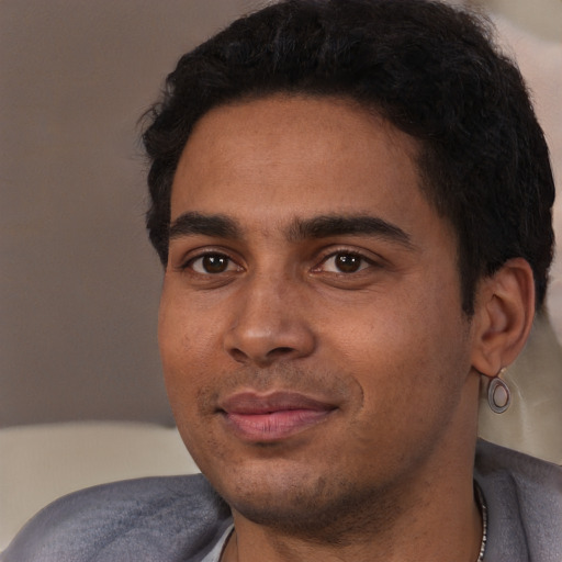 Joyful white young-adult male with short  black hair and brown eyes