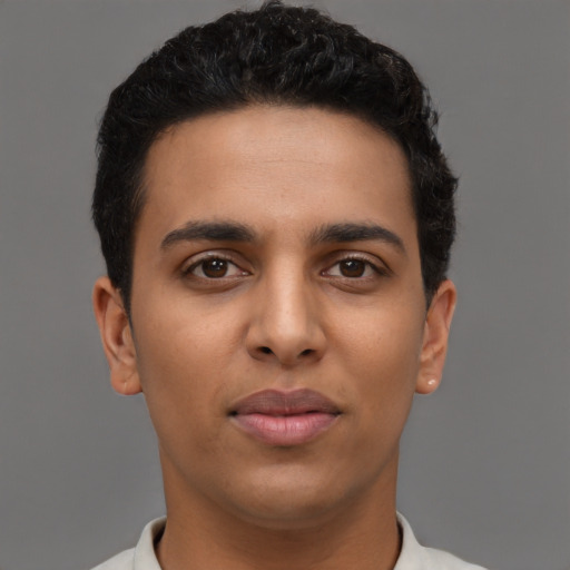 Joyful latino young-adult male with short  brown hair and brown eyes