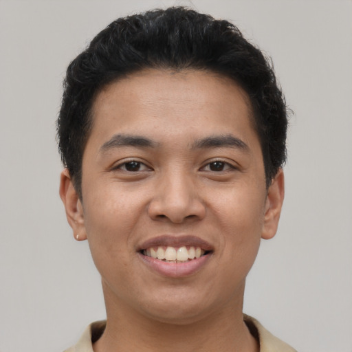 Joyful asian young-adult male with short  brown hair and brown eyes