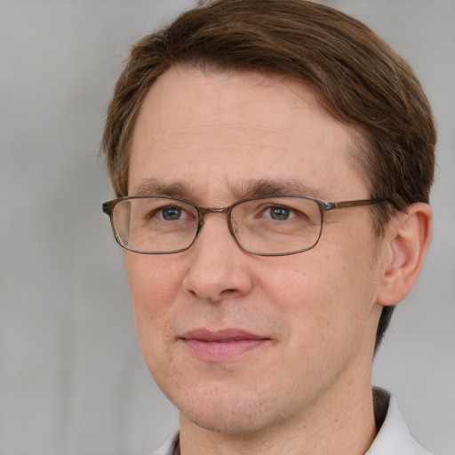 Joyful white adult male with short  brown hair and grey eyes