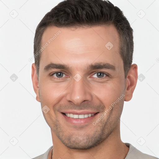 Joyful white young-adult male with short  brown hair and brown eyes