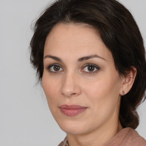 Joyful white adult female with medium  brown hair and brown eyes