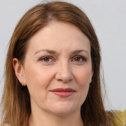 Joyful white adult female with long  brown hair and brown eyes