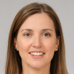 Joyful white young-adult female with long  brown hair and grey eyes