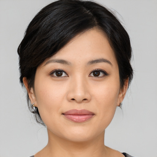 Joyful asian young-adult female with medium  brown hair and brown eyes