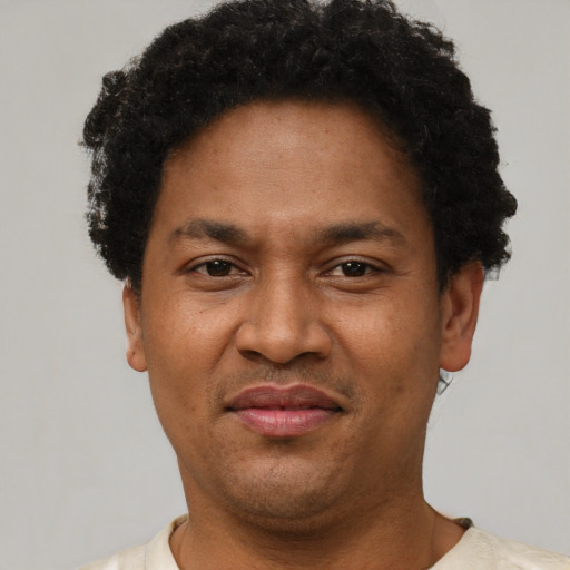 Joyful latino adult male with short  brown hair and brown eyes