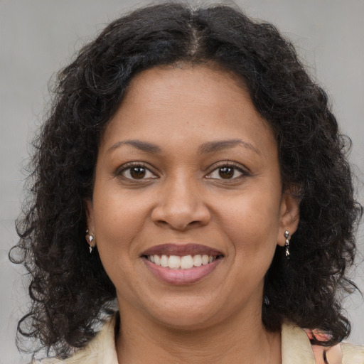Joyful latino adult female with long  brown hair and brown eyes