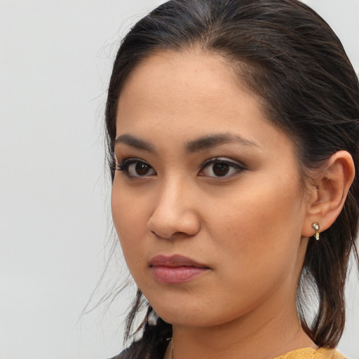 Joyful asian young-adult female with long  brown hair and brown eyes