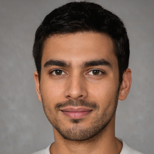 Joyful latino young-adult male with short  black hair and brown eyes