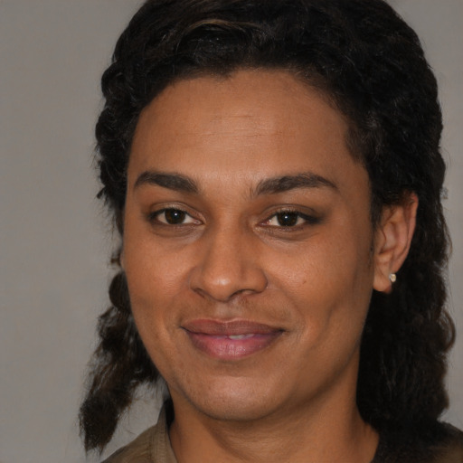 Joyful black adult female with medium  black hair and brown eyes