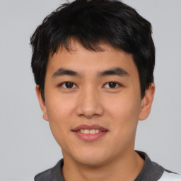 Joyful asian young-adult male with short  black hair and brown eyes