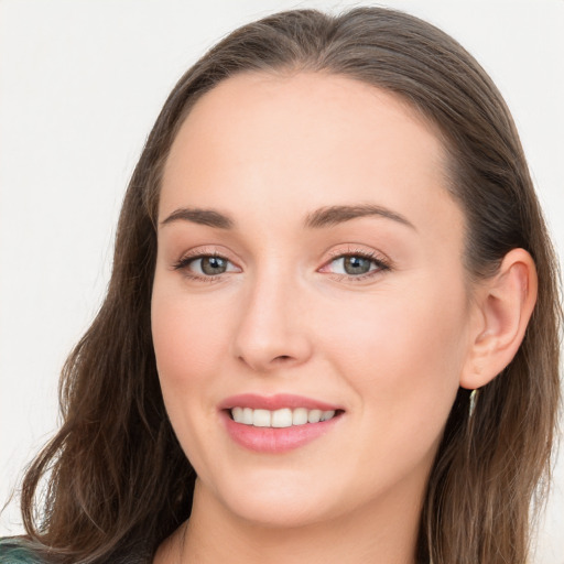 Joyful white young-adult female with long  brown hair and blue eyes