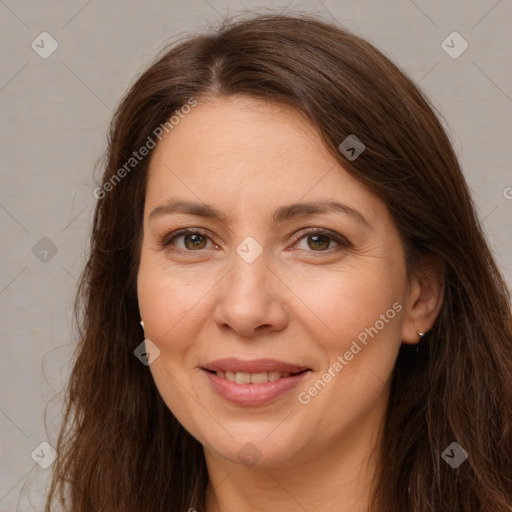 Joyful white adult female with long  brown hair and brown eyes