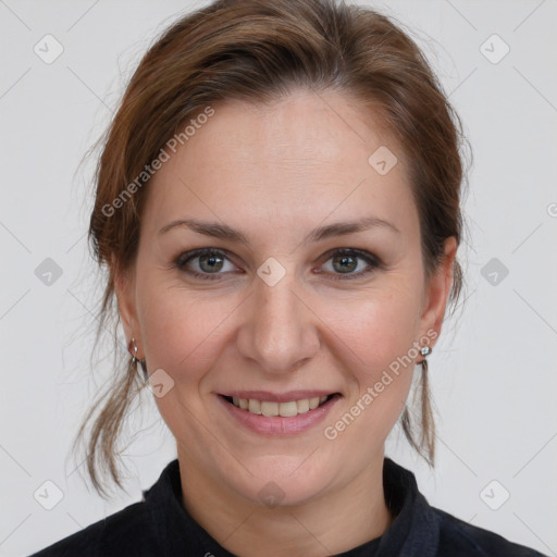 Joyful white adult female with medium  brown hair and grey eyes