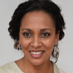 Joyful black adult female with medium  brown hair and brown eyes