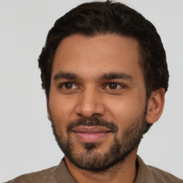 Joyful latino young-adult male with short  black hair and brown eyes