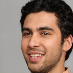 Joyful white young-adult male with short  black hair and brown eyes