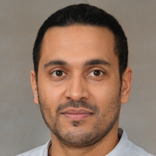 Neutral latino young-adult male with short  black hair and brown eyes