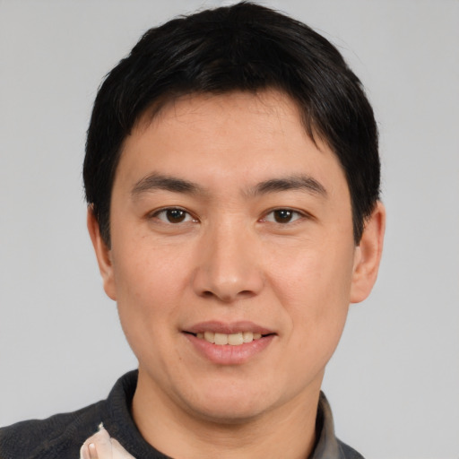 Joyful white young-adult male with short  black hair and brown eyes