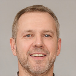 Joyful white adult male with short  brown hair and brown eyes