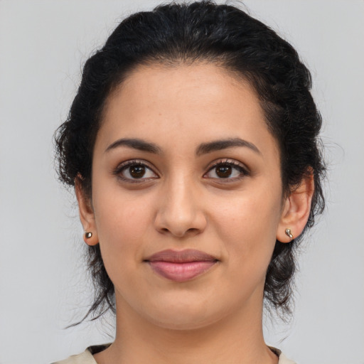 Joyful latino young-adult female with medium  black hair and brown eyes