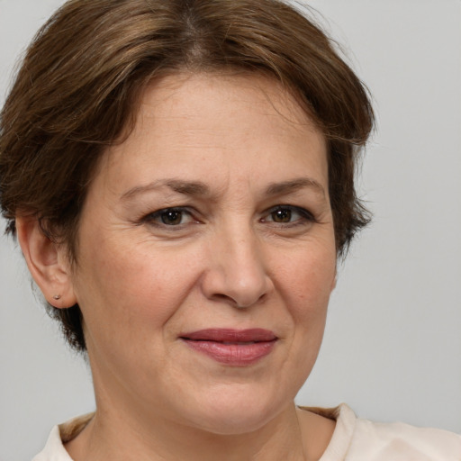 Joyful white adult female with medium  brown hair and brown eyes