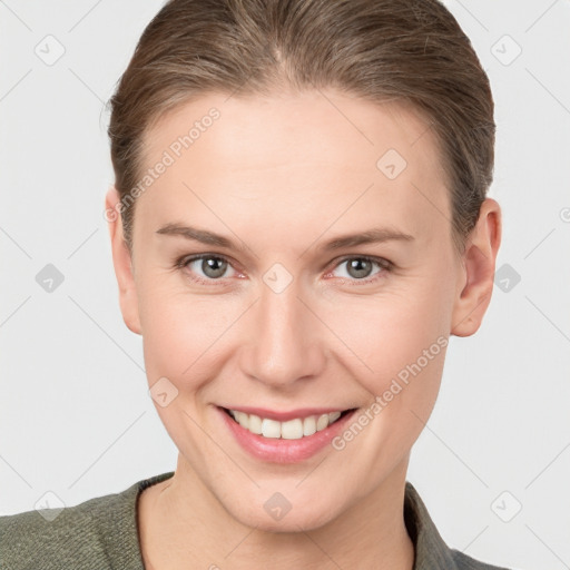 Joyful white young-adult female with short  brown hair and grey eyes