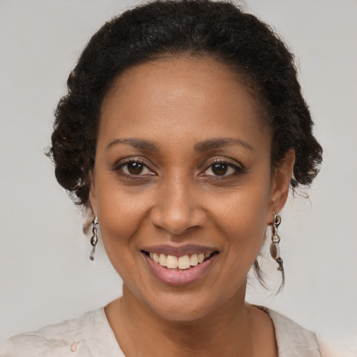 Joyful black adult female with short  brown hair and brown eyes