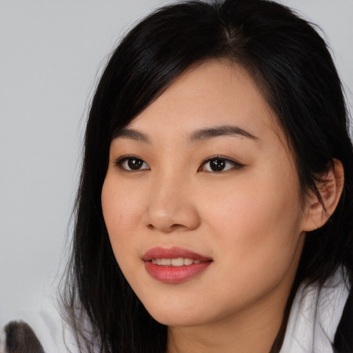 Joyful asian young-adult female with medium  black hair and brown eyes