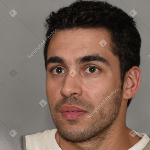 Joyful white young-adult male with short  black hair and brown eyes