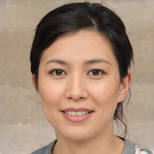 Joyful asian young-adult female with medium  brown hair and brown eyes