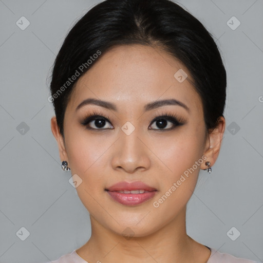 Joyful asian young-adult female with short  black hair and brown eyes