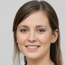 Joyful white young-adult female with long  brown hair and grey eyes