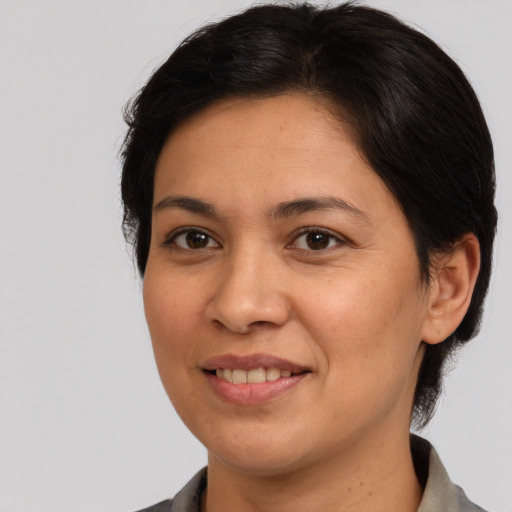 Joyful white adult female with medium  brown hair and brown eyes