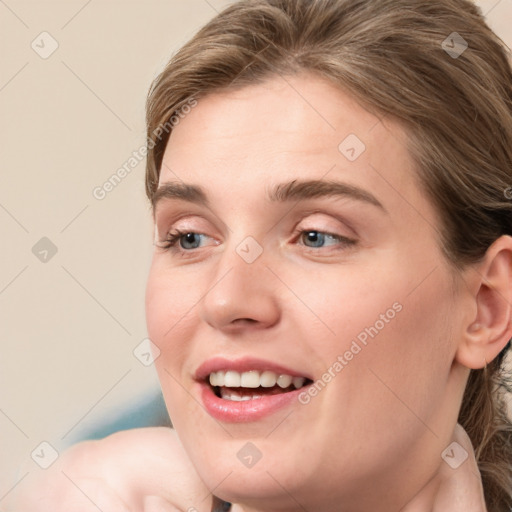 Joyful white young-adult female with medium  brown hair and blue eyes