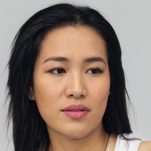 Joyful asian young-adult female with medium  black hair and brown eyes