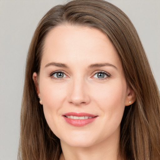 Joyful white young-adult female with long  brown hair and grey eyes