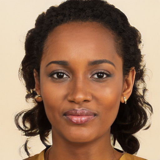 Joyful black young-adult female with long  brown hair and brown eyes