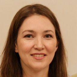 Joyful white adult female with long  brown hair and brown eyes