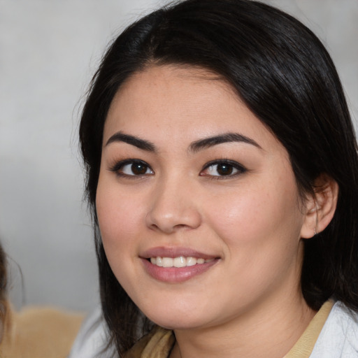 Joyful white young-adult female with medium  black hair and brown eyes