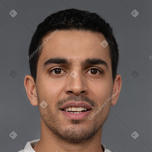 Joyful latino young-adult male with short  brown hair and brown eyes