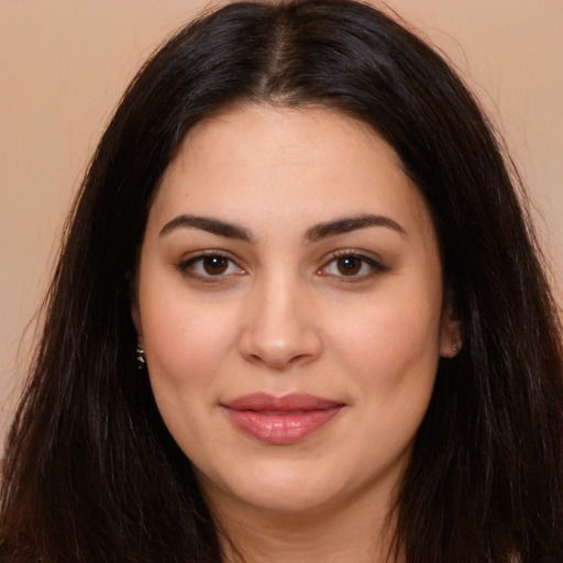 Joyful latino young-adult female with long  brown hair and brown eyes