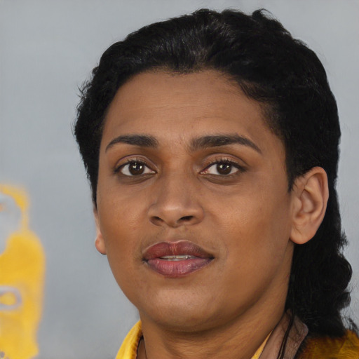 Joyful black adult female with short  black hair and brown eyes