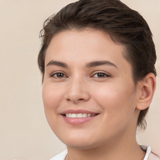 Joyful white young-adult female with short  brown hair and brown eyes