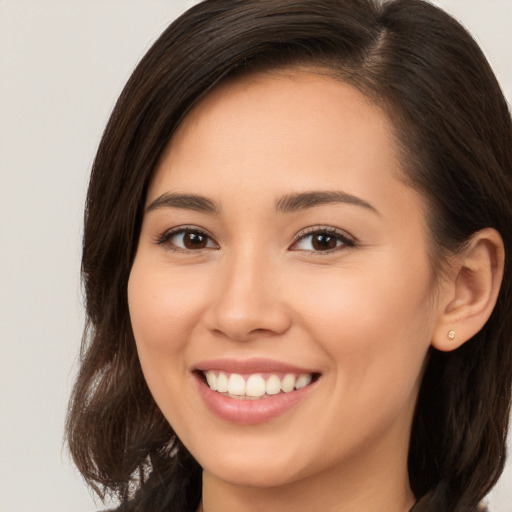 Joyful white young-adult female with long  brown hair and brown eyes