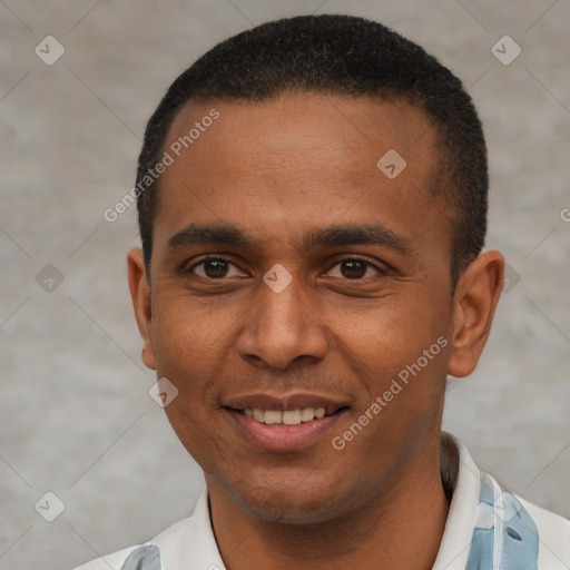 Joyful latino young-adult male with short  black hair and brown eyes