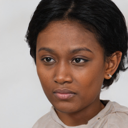 Neutral black young-adult female with medium  brown hair and brown eyes