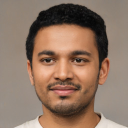 Joyful latino young-adult male with short  black hair and brown eyes