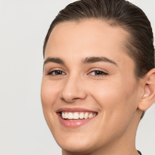 Joyful white young-adult female with short  brown hair and brown eyes