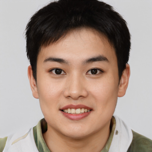 Joyful white young-adult male with short  black hair and brown eyes